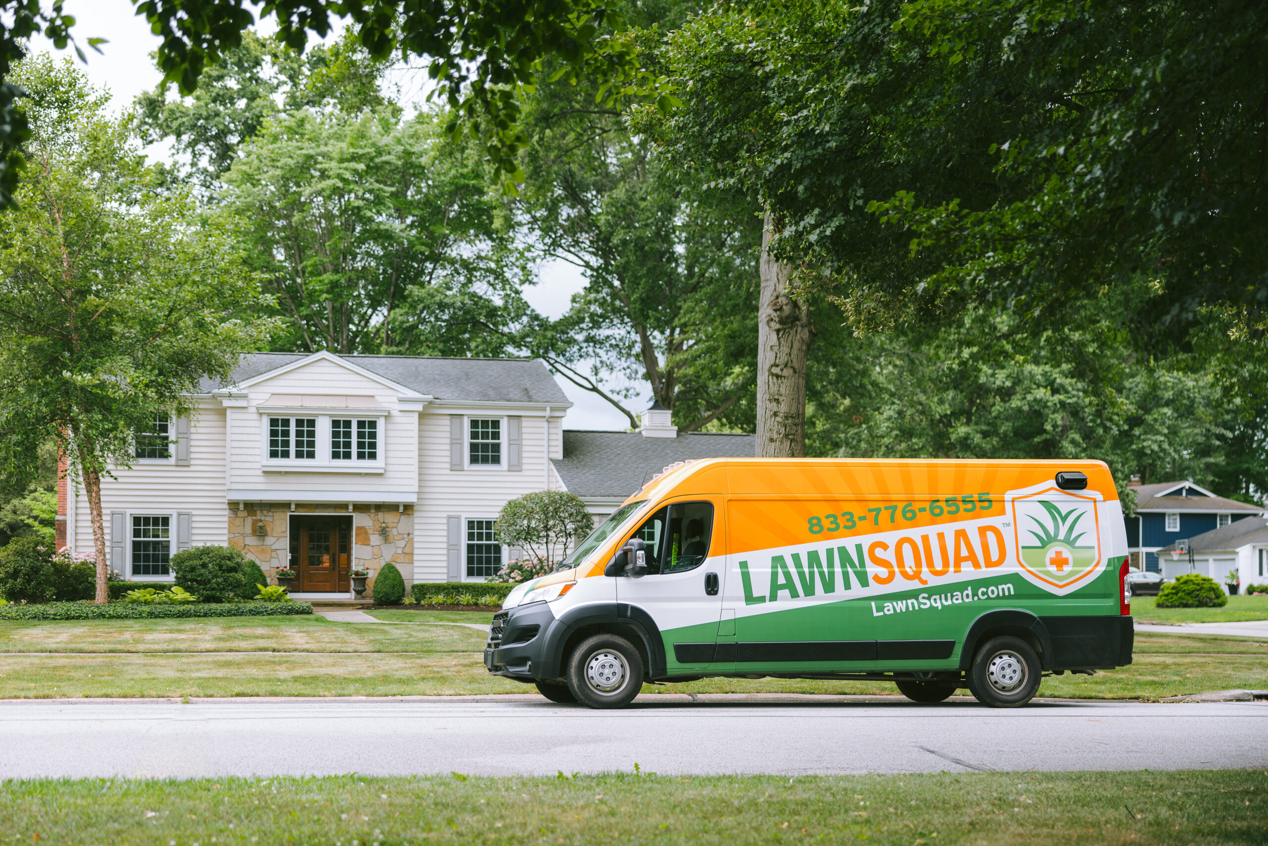 lawn squad van in front of house