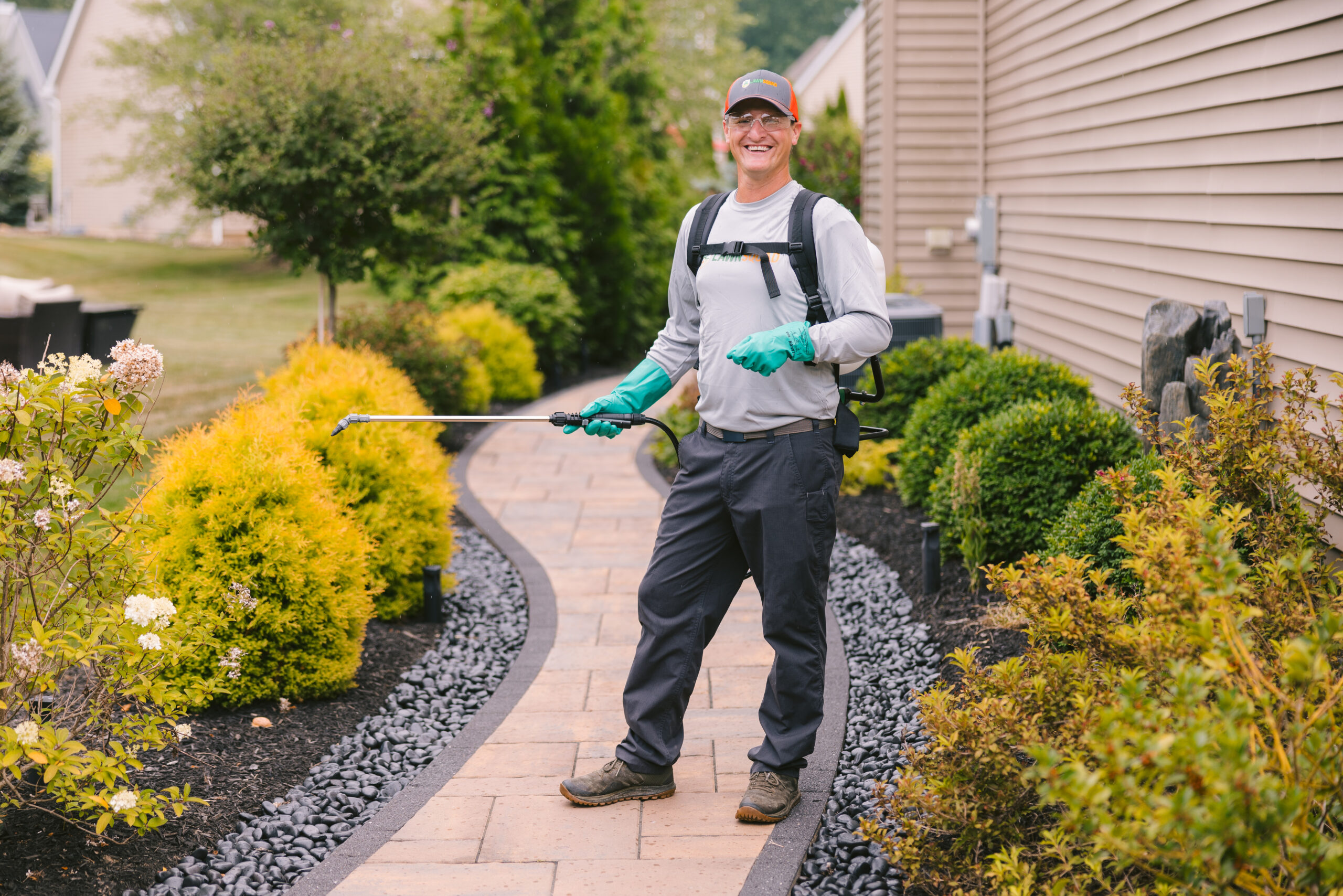 guy smiling in front of lawn