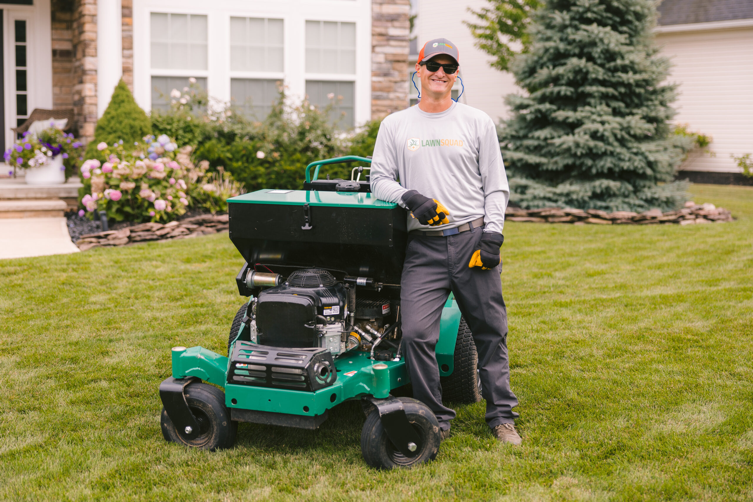 man in front of house on equipment