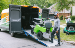 A man loading lawn care equipment