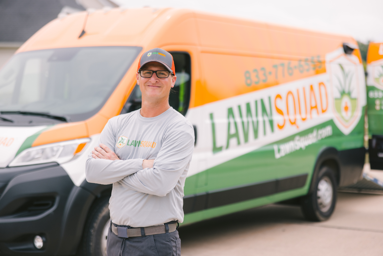 Man crossing his arms in front of a van