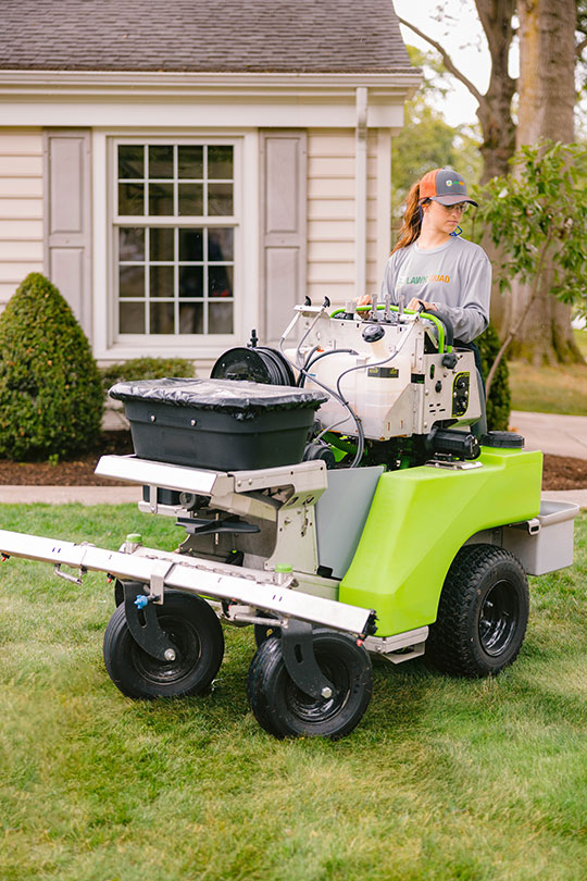 women on lawn care equipment